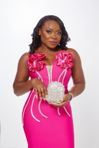 pick cocktail dress paired with a gemstone clutch